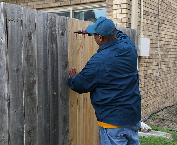 Man Fixing Gate