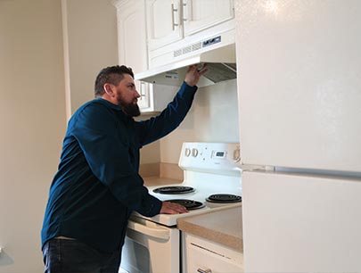 Man Inspecting Kitchen Mountedrange Hood