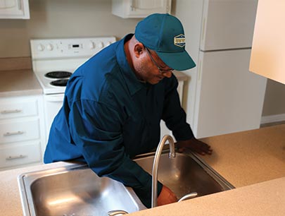 Man Inspecting Kitchen Sink