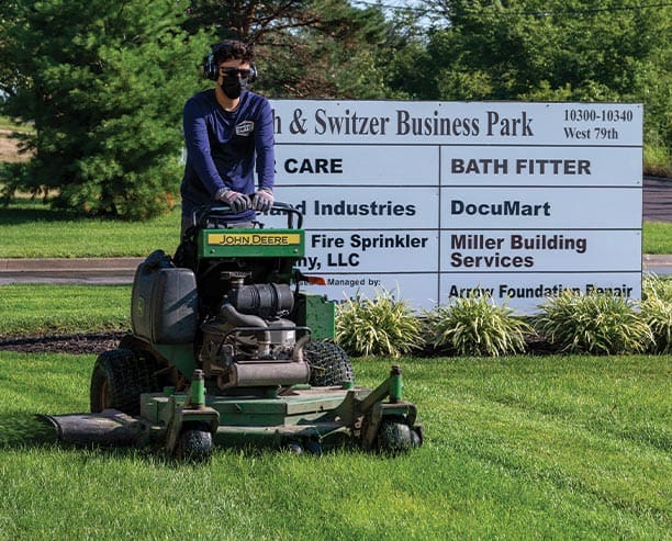 Man Using Gas Riding Lawn Mower