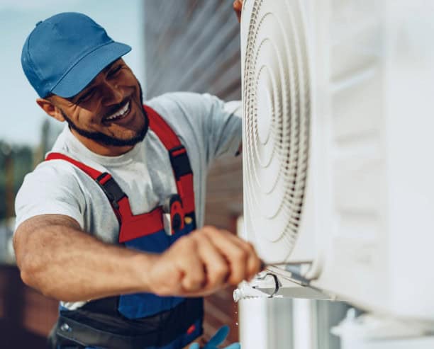 Young Black Man Repairman Checking An Outside Air Conditioner Unit