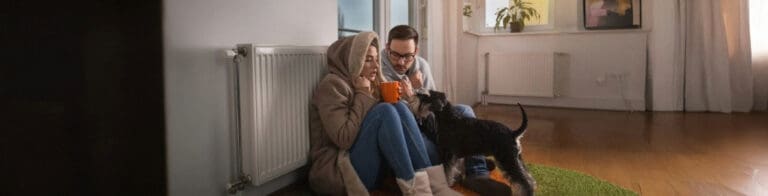 family in cold house huddling for warmth