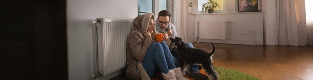 family in cold house huddling for warmth